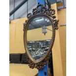 AN ORNATE WOODEN FRAMED MIRROR