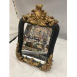 A VINTAGE STYLE MIRROR WITH A BLACK FRAME AND ORNATE GILDING