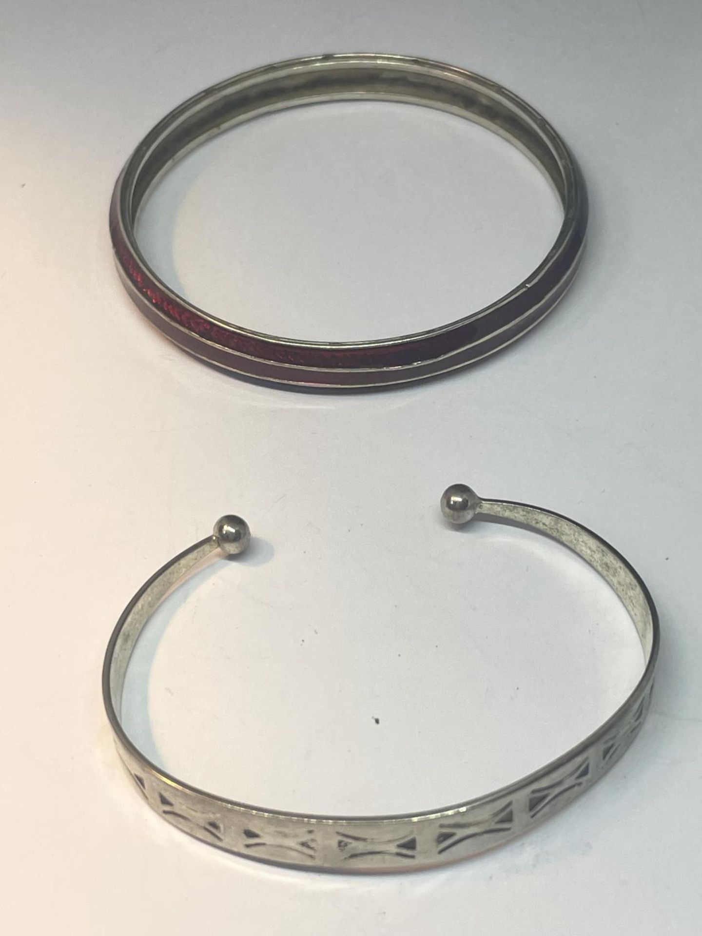 TWO MARKED SILVER BANGLES ONE WITH RED ENAMEL