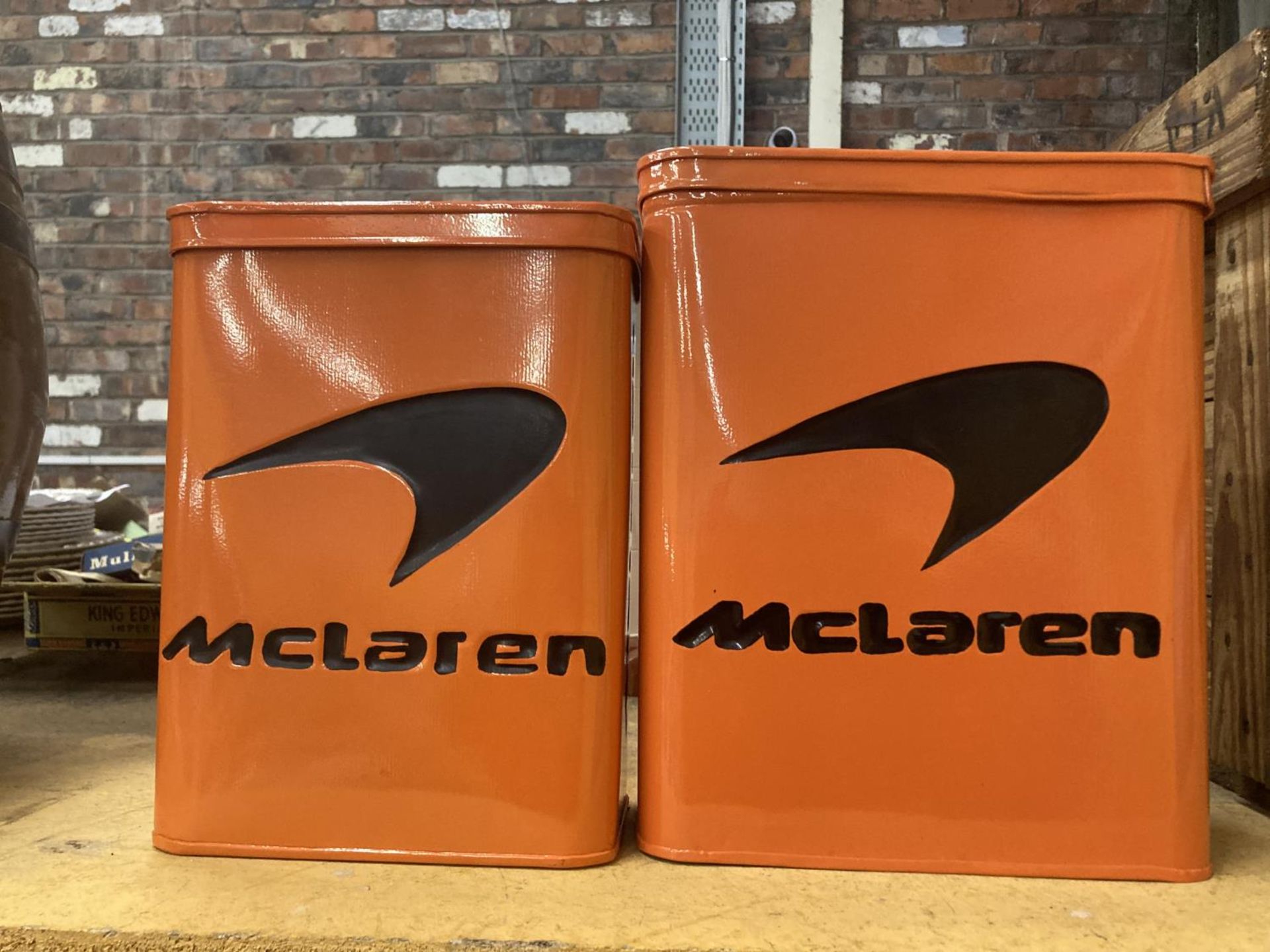 TWO ORANGE McCLAREN STORAGE TINS