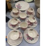 A WADE TEASET IN PINK WITH A ROSE PATTERN TO INCLUDE A CAKE PLATE, CREAM JUG, SUGAR BOWL, CUPS,