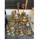 A LARGE QUANTITY OF BRASS HAND BELLS TO INCLUDE A BRASS SHIPS BELL WITH WOODEN PLINTH AND PULLEY