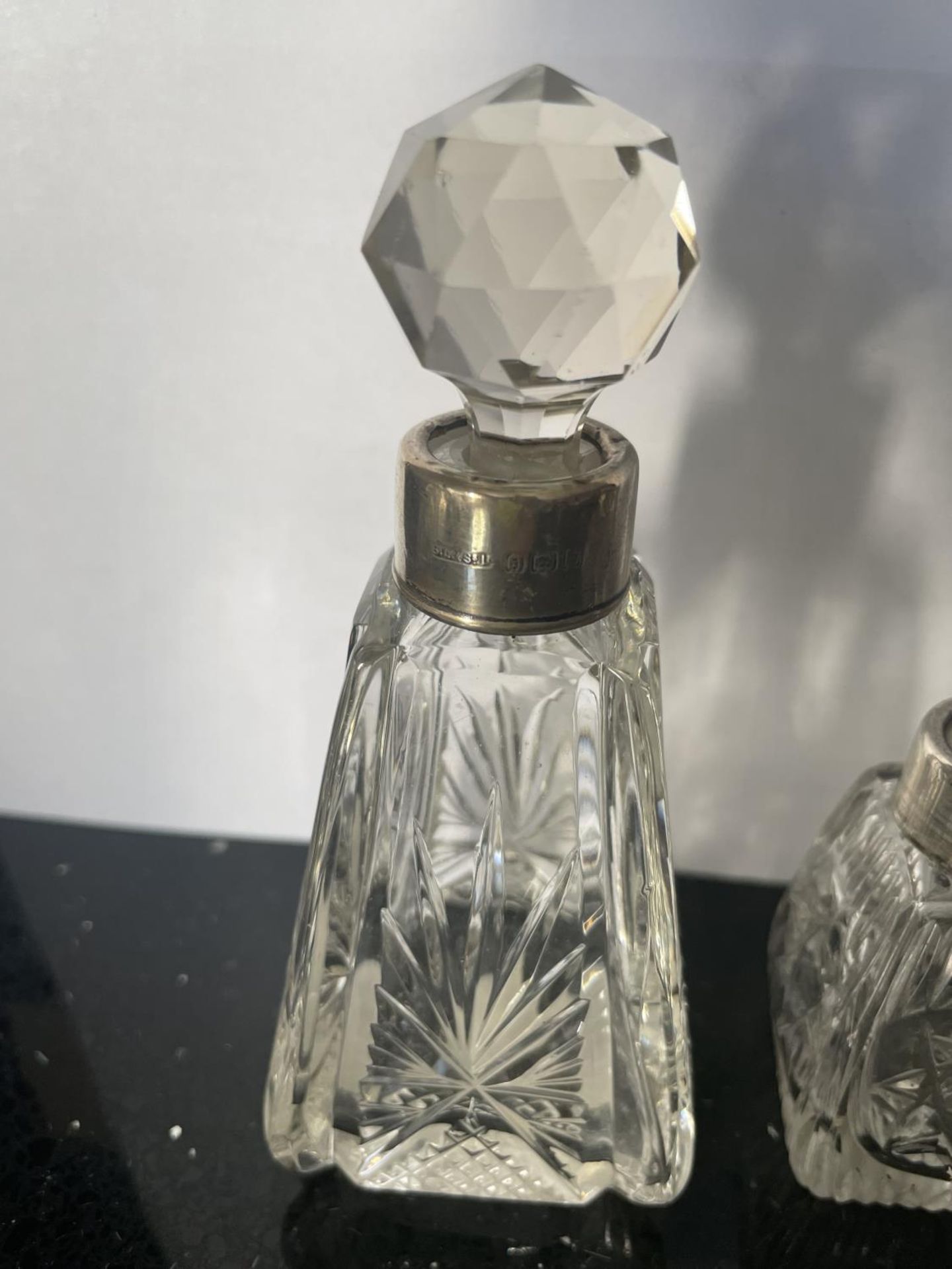 THREE CUT GLASS PERFUME BOTTLE WITH HALLMARKED LONDON SILVER COLLARS - Image 2 of 4