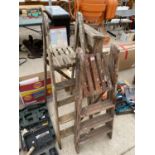 THREE VINTAGE WOODEN STEP LADDERS TO INCLUDE A THREE RUNG AND TWO FOUR RUNGS