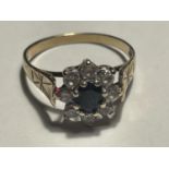 A 9 CARAT GOLD RING WITH A CENTRE SAPPHIRE SURROUNDED BY EIGHT CUBIC ZIRCONIAS SIZE M