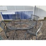 A METAL PATIO FURNITURE SET WITH OVAL TABLE AND FOUR CHAIRS