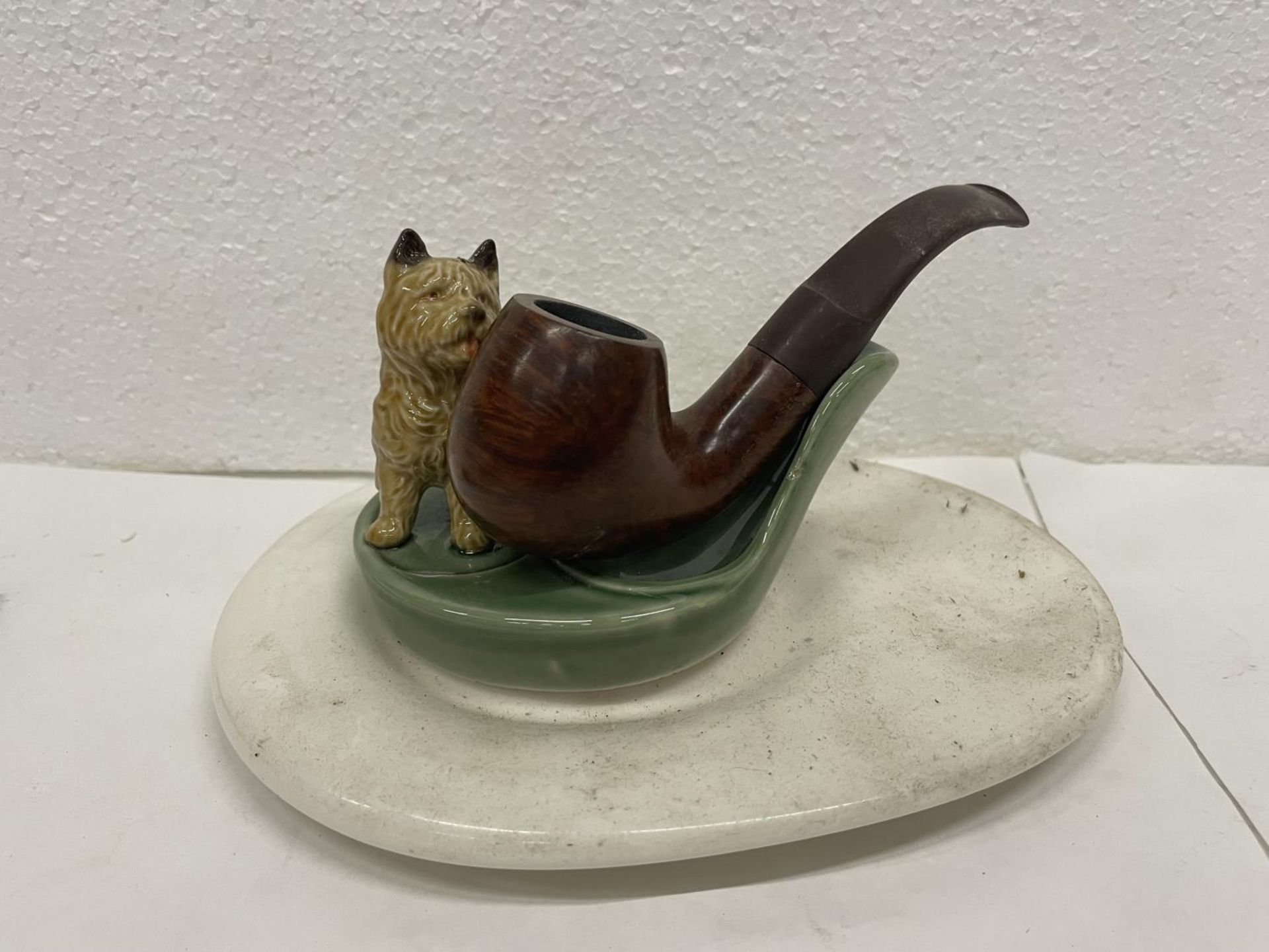 A WADE DOG PIPE STAND WITH PIPE AND BASE