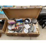 A VINTAGE TRAVEL TRUNK CONTAINING A LARGE COLLECTION OF FILM REELS
