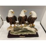 A RESIN MODEL OF A GROUP OF THREE BALD EAGLES ON A BRANCH BY THE JULIANA COLLECTION HEIGHT 29CM,
