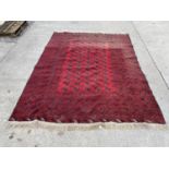 A RED AND BLACK GROUND FRINGED CARPET, 100X80"