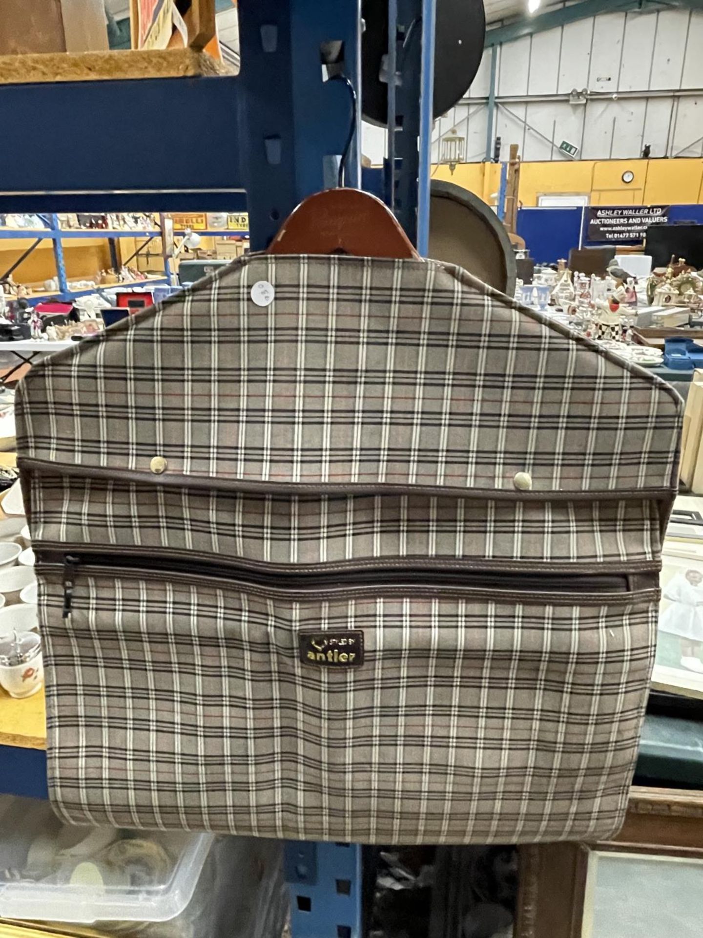 A CHECKED SUIT CARRIER MADE BY ANTLER