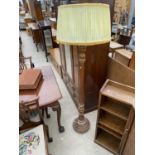 A MID 20TH CENTURY STANDARD LAMP WITH TURNED AND FLUTED COLUMN WITH FOLIATE CARVING TO THE BASE