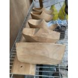 A WOODEN BOARD AND FIVE WOODEN CLOG MOULDS