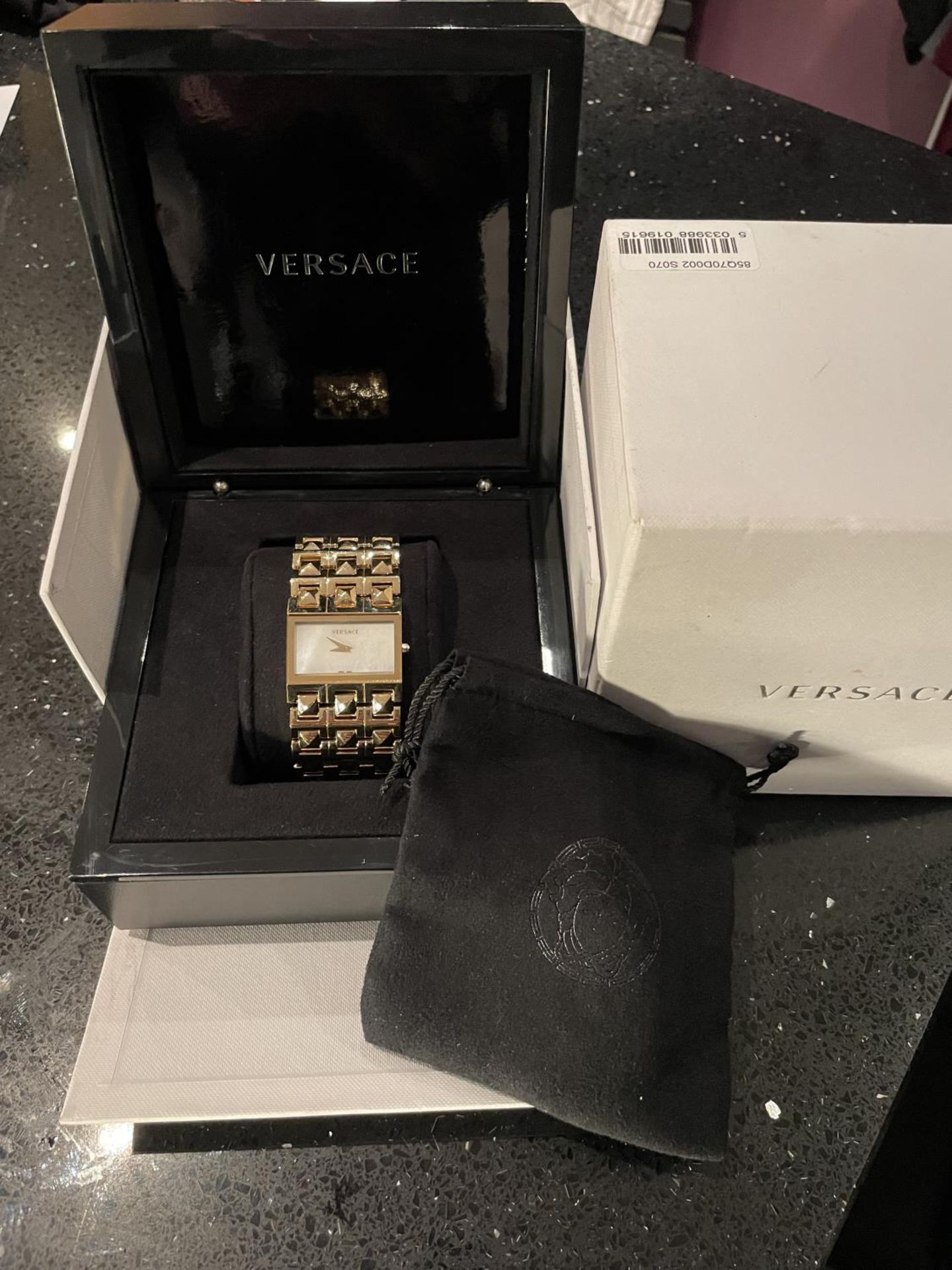 A BOXED VERSACE WRIST WATCH WITH PERALISED RECTANGULAR FACE SOFT BAG ETC