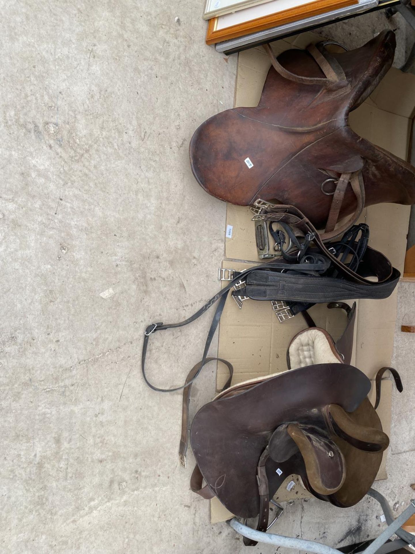 AN ASSORTMENT OF HORSE TACK TO INCLUDE TWO LEATHER SADDLES AND STIRRUPS ETC