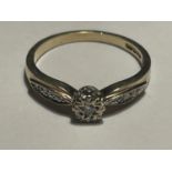 A 9 CARAT GOLD RING WITH A CENTRE DIAMOND AND DIAMONDS ON THE SHOULDERS SIZE P