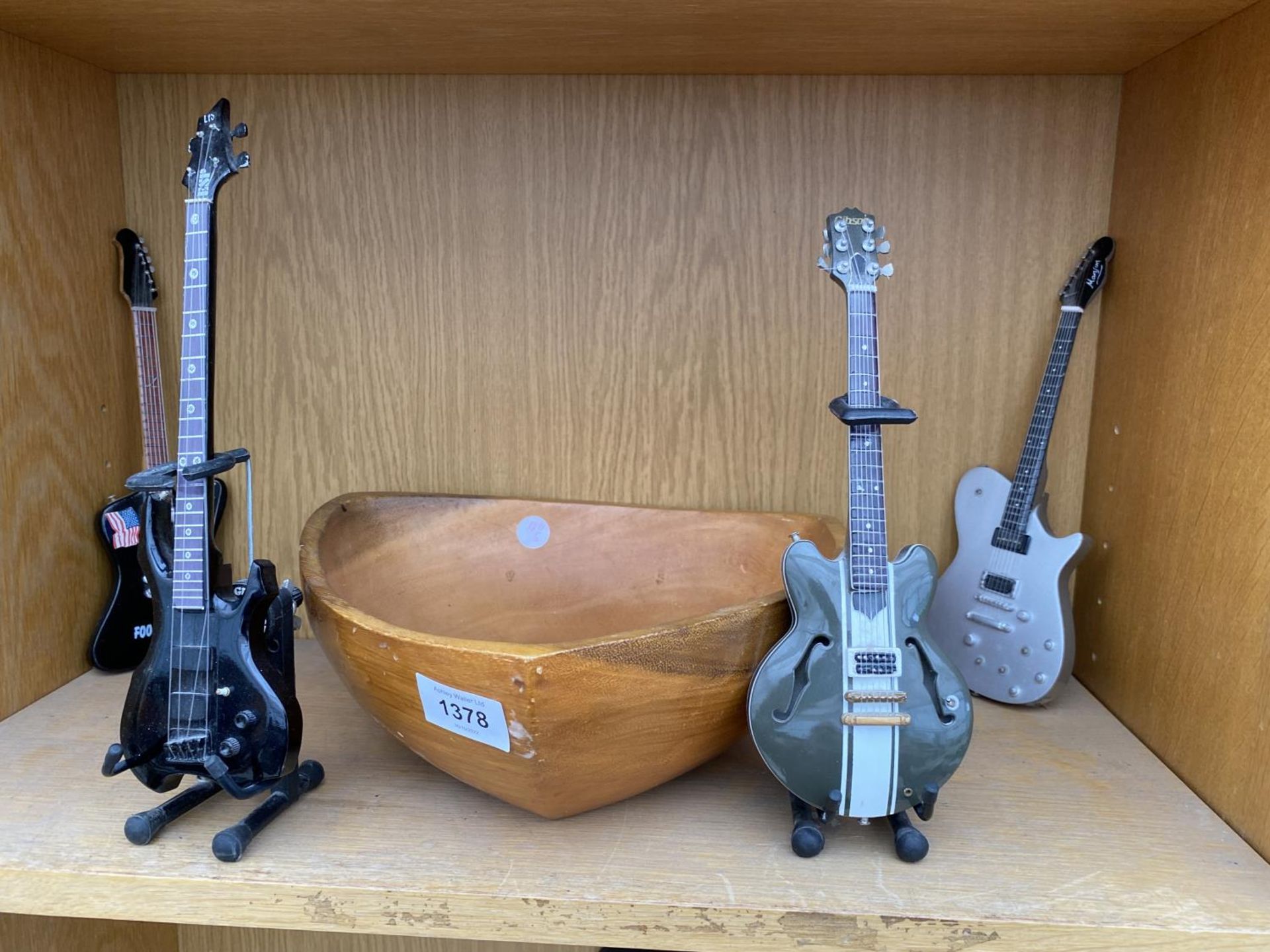 A TREEN FRUIT BOWL AND FOUR MINITURE MODEL GUITARS