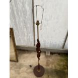 A RETRO TEAK AND BRASS STANDARD LAMP