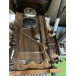 A LARGE MAHOGANY AND GLASS CASED WALL CLOCK WITH COLUMN DECORATION TO INCLUDE PENDULUM AND WEIGHTS