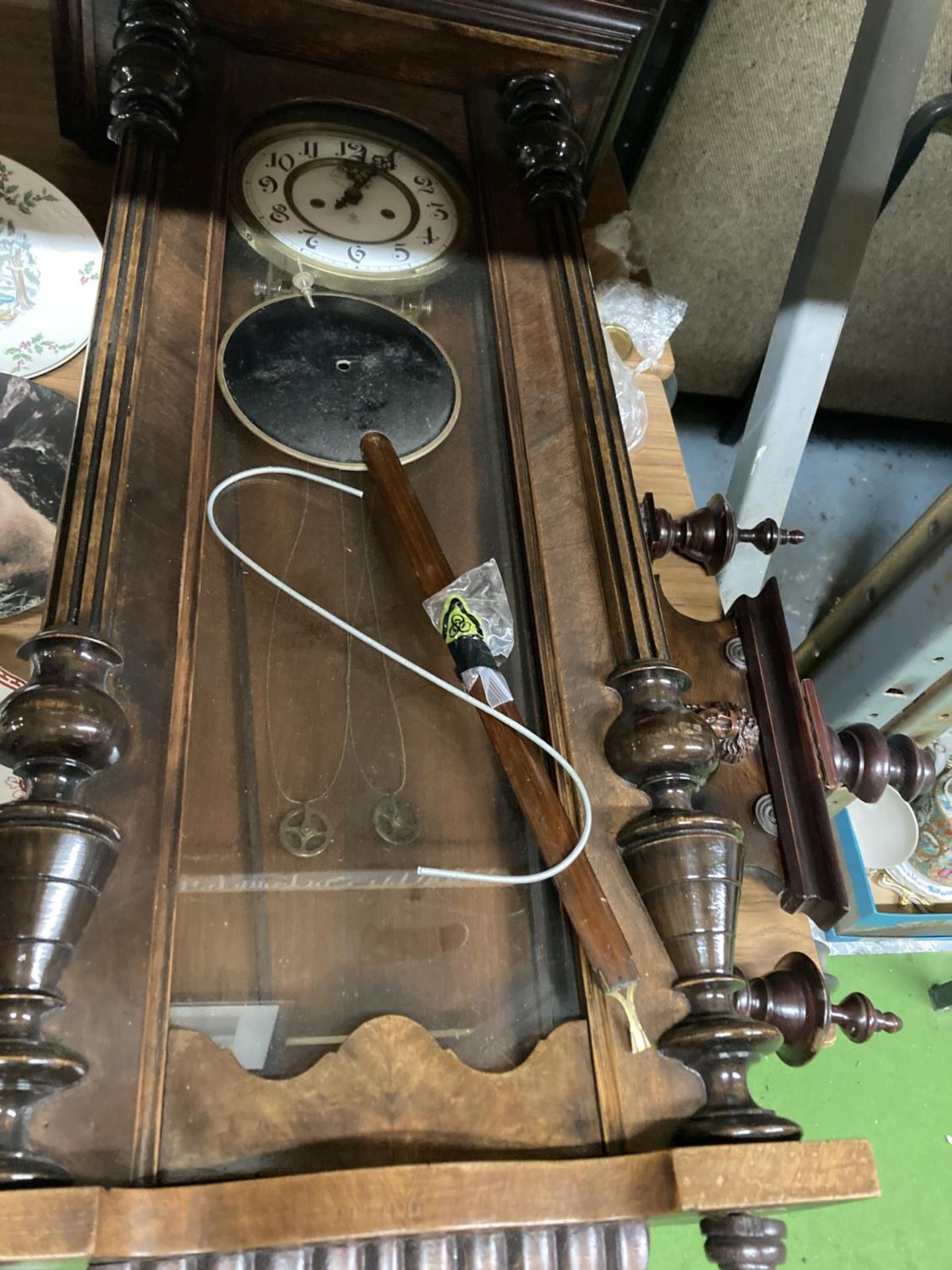 A LARGE MAHOGANY AND GLASS CASED WALL CLOCK WITH COLUMN DECORATION TO INCLUDE PENDULUM AND WEIGHTS