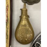 A VINTAGE BRASS POWDER FLASK WITH EMBOSSED USAND EAGLE TO FRONT AND REAR