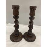 A PAIR OF WOODEN BARLEY TWIST CANDLESTICKS