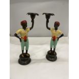 A PAIR OF COLD PAINTED BERGMAN STYLE CANDLESTICKS