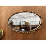 A DECORATIVE GILT FRAMED WALL MIRROR