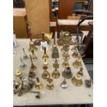 A LARGE QUANTITY OF BRASS HAND BELLS TO INCLUDE A BRASS SHIPS BELL WITH WOODEN PLINTH AND PULLEY