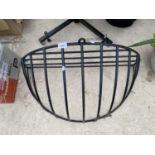 A WROUGHT IRON CURVED HAY RACK PLANTER