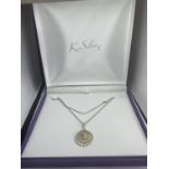 A MARKED SILVER NECKLACE WITH A LARGE DECORATIVE SILVER PENDANT IN A PRESENTATION BOX