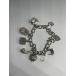 A SILVER CHARM BRACELET WITH EIGHT CHARMS