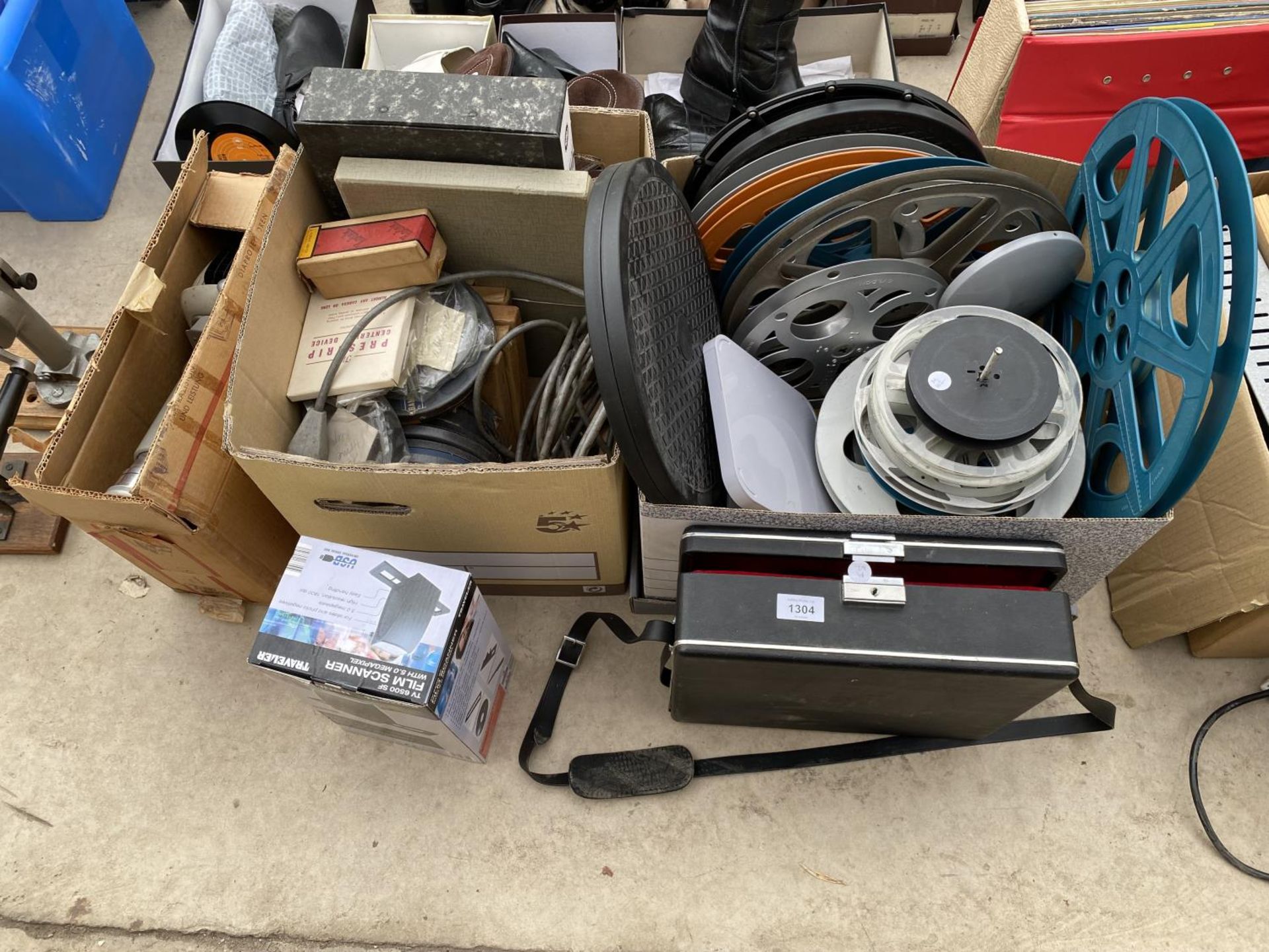 AN ASSORTMENT OF ITEMS TO INCLUDE FILM REELS, A PROJECTOR AND EMPTY FILM REELS ETC