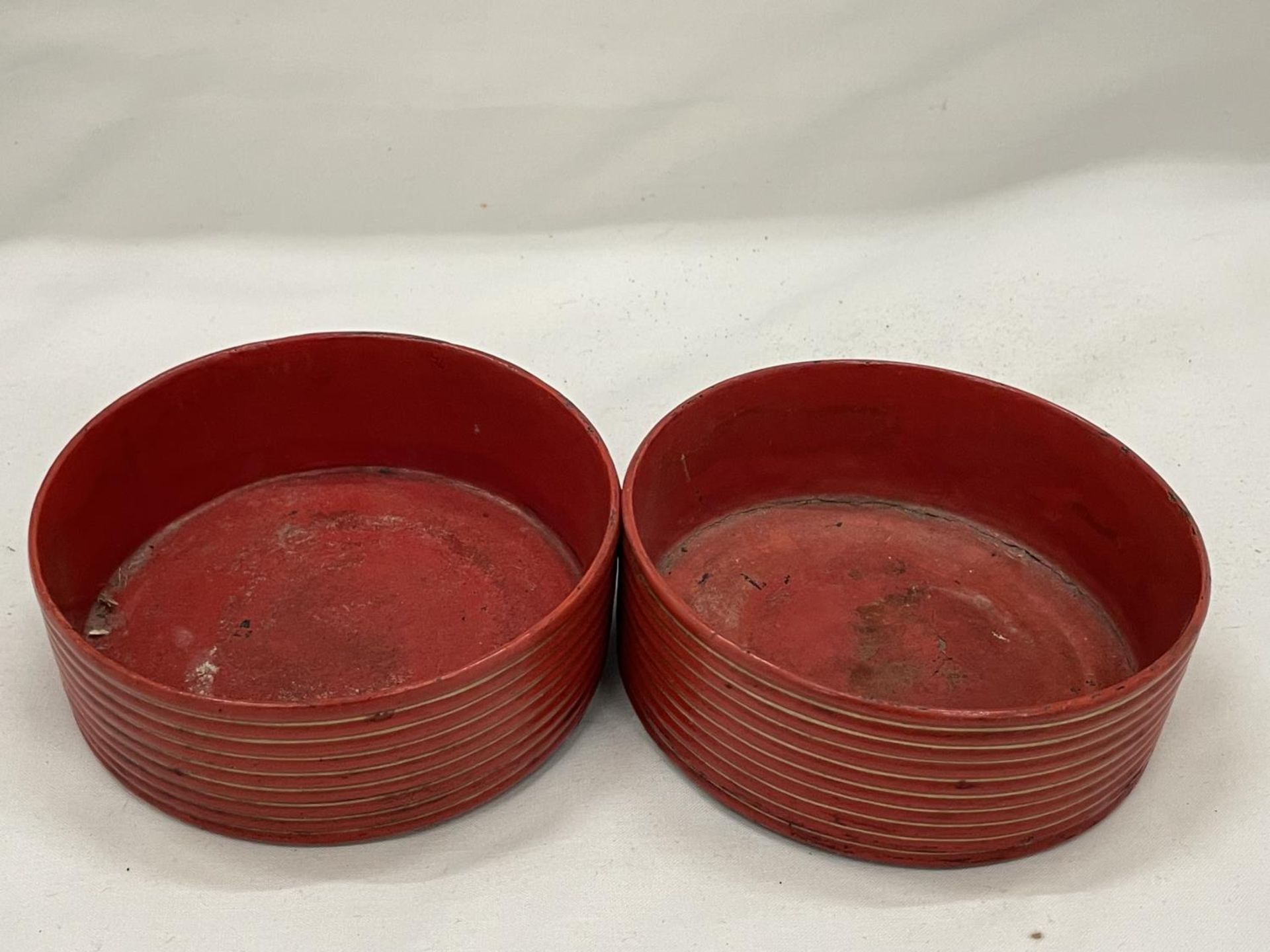 A PAIR OF BELIEVED ENGLISH REGENCY CIRCA 19TH CENTURY WINE COASTERS IN CINNABAR RED LACQUER