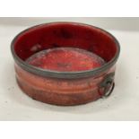 A BELIEVED ENGLISH REGENCY CIRCA 19TH CENTURY WINE COASTER IN CINNABAR RED LACQUER WITH RING HANDLES