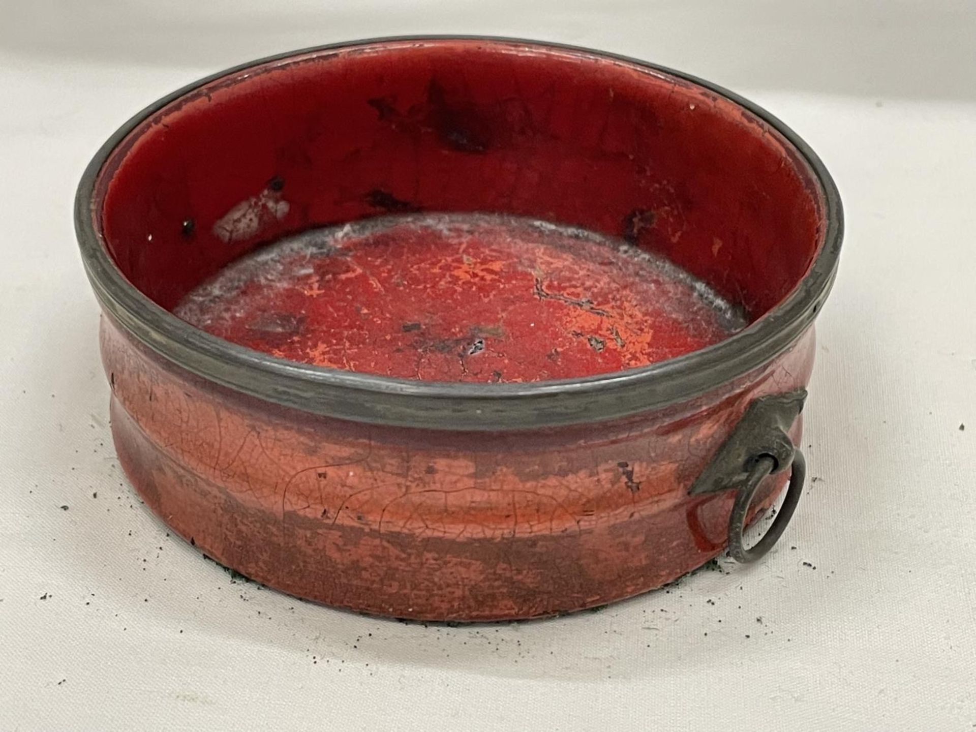 A BELIEVED ENGLISH REGENCY CIRCA 19TH CENTURY WINE COASTER IN CINNABAR RED LACQUER WITH RING HANDLES