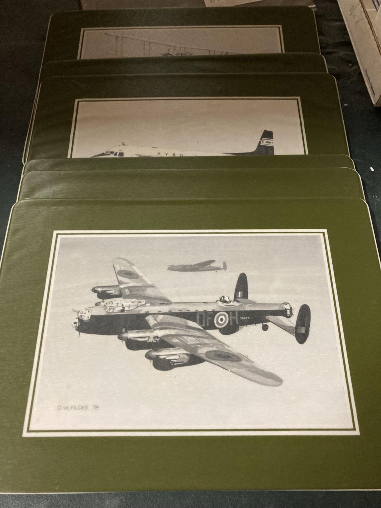 A SET OF SIX BRITISH AEROSPACE PLASTIC PLACEMATS FEATURING DIFFERENT AVRO AIRCRAFT, SIGNED AND DATED