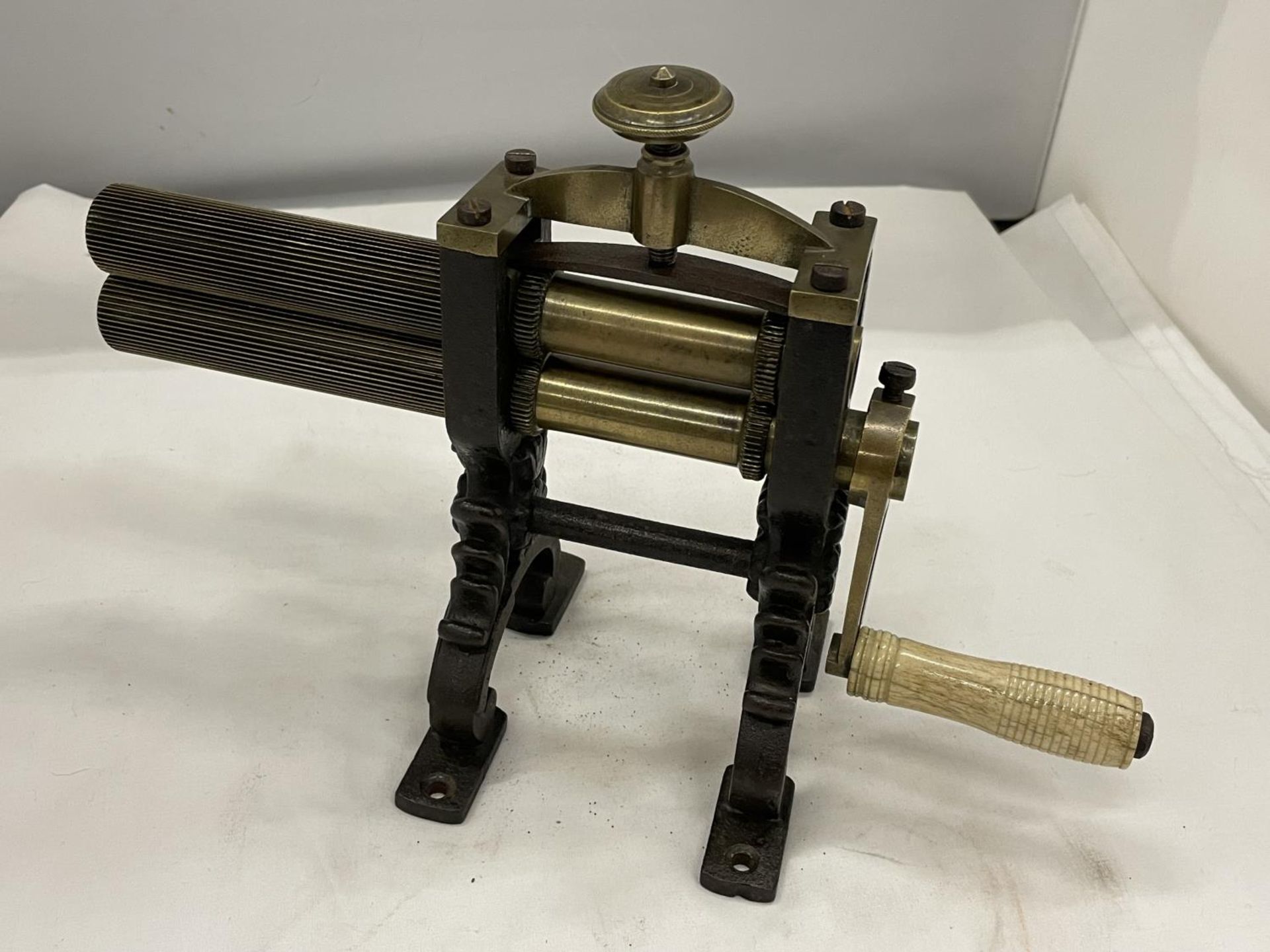 A VICTORIAN BRASS AND CAST CRIMPING MACHINE FOR PLEATING AND RUFFLING LAUNDERED AND STARCHED CUFFS