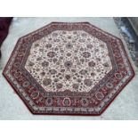 A RED AND GREEN GROUND OCTAGONAL 'KASHMIR' POWERLOOM CARPET