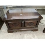 A SMALL CARVED OAK TV STAND