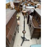 A VICTORIAN WROUGHT IRON OIL STANDARD LAMP WITH SPIRAL COLUMN AND ORNATE BASE, HAVING COPPER LAMP (