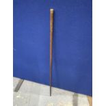 A WALKING CANE WITH AN 18 CARAT GOLD FINIAL DATED 1889 AND ENGRAVED