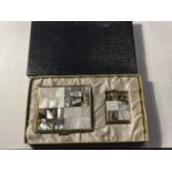 A VINTAGE BOXED SET COMPRISING OF A MOTHER OF PEARL HILTON LIGHTER AND A MATCHING MIRRORED COMPACT