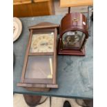 A WOODEN CASED WALL CLOCK AND A MANTLE CLOCK