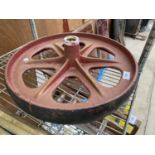 A VINTAGE CAST IRON PULLEY WHEEL