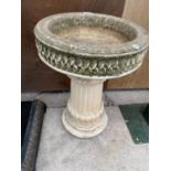 A RECONSTITUTED STONE BIRD BATH WITH PEDESTAL BASE