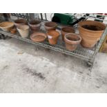 AN ASSORTMENT OF TERRACOTTA PLANT POTS OF VARIOUS SIZES