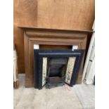 A VICTORIAN CAST IRON FIRE PLACE WITH TILED SURROUND AND UNRELATED WOODEN FIRE SURROUND