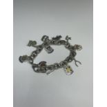 A MARKED SILVER CHARM BRACELET WITH TEN CHARMS