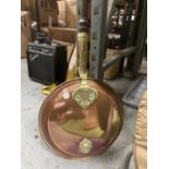 A VINTAGE BRASS AND COPPER BED WARMER